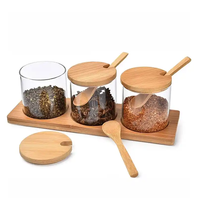 HIK001 3-in-1 clear glass canister set with natural bamboo lids, spoons, and tray displayed on a white kitchen counter — eco-friendly kitchen storage jars from HomeImports Kenya